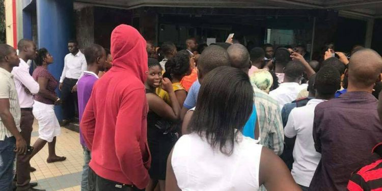 Customers line up to withdraw their money from Midland Savings and Loans