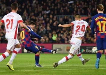 Messi hat-trick sends Barcelona top