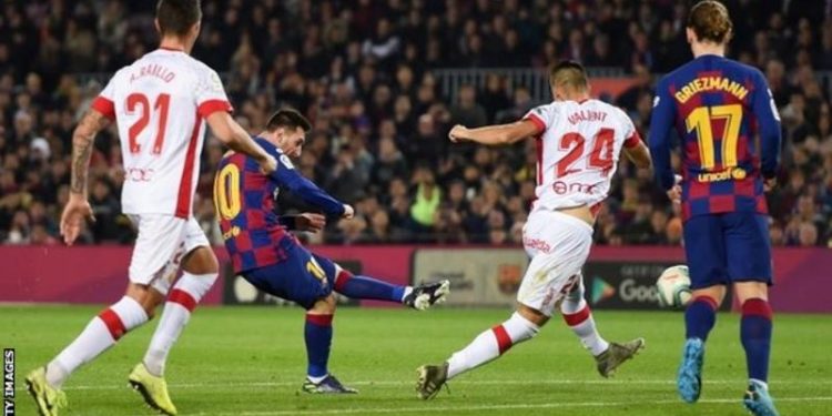 Messi hat-trick sends Barcelona top