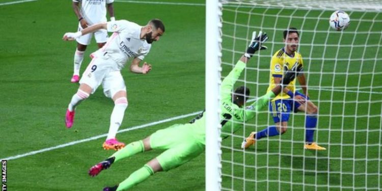 Benzema double takes Real level at the top